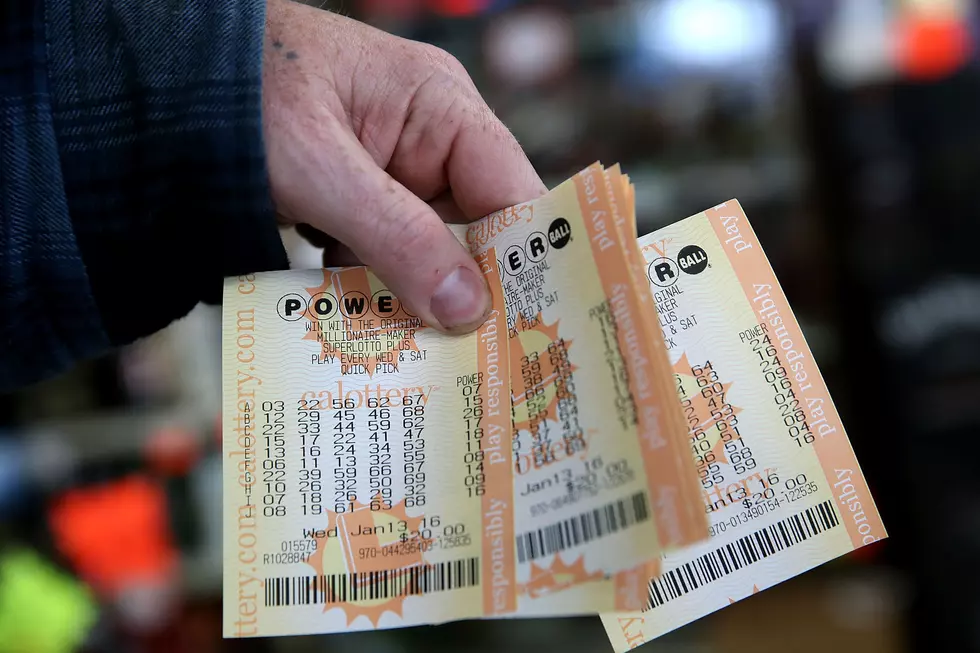 Person Holding a Stack of Powerball Tickets